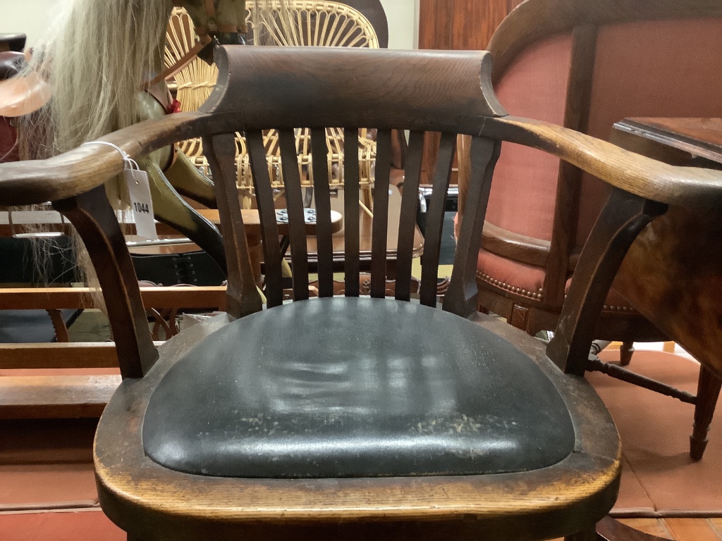 An early 20th century oak desk chair, width 66cm